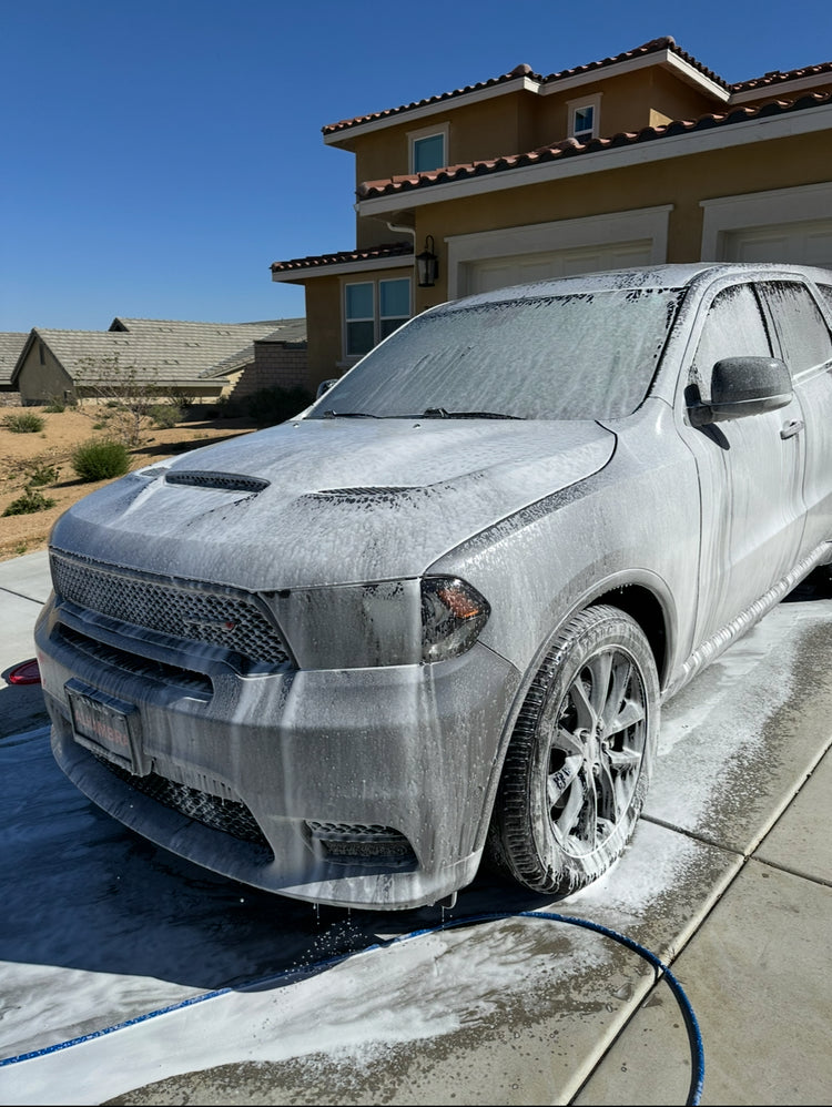 SUV covered in pH-neutral foam during the wash